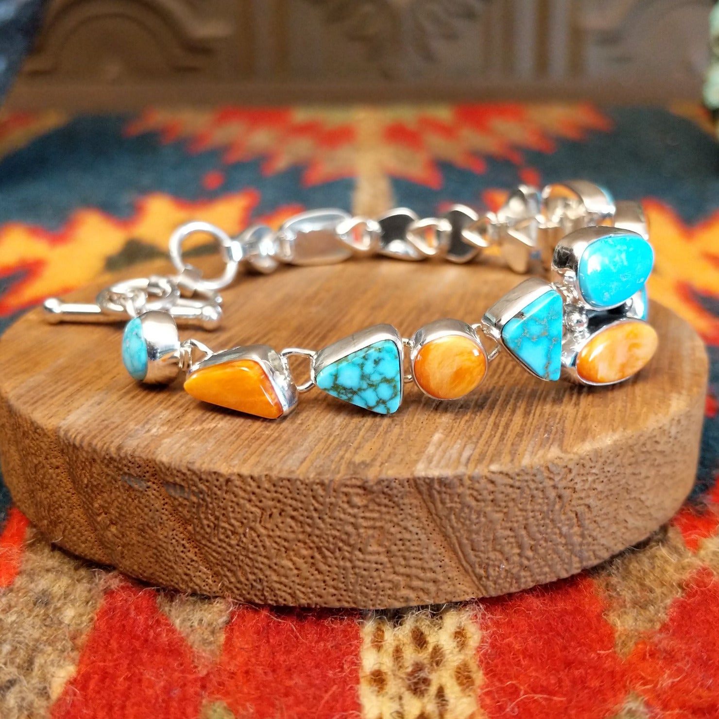 Sterling silver bracelet with Kingman turquoise and orange spiny oyster shell set in geometric bezels that make up the band.