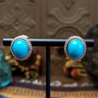 Sterling silver Kingman Turquoise stud earrings featuring oval blue stones with twisted rope borders.