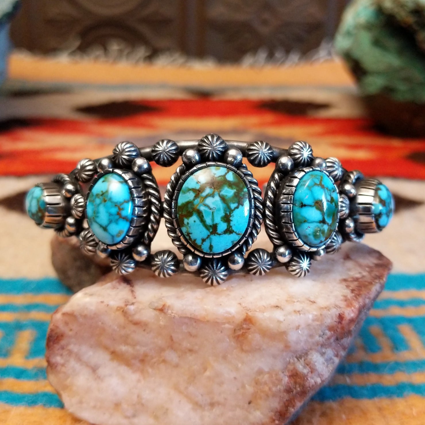 Sterling silver pentad cuff with Kingman turquoise set in round bezels, framed by twisted rope, star, and dotted accents.