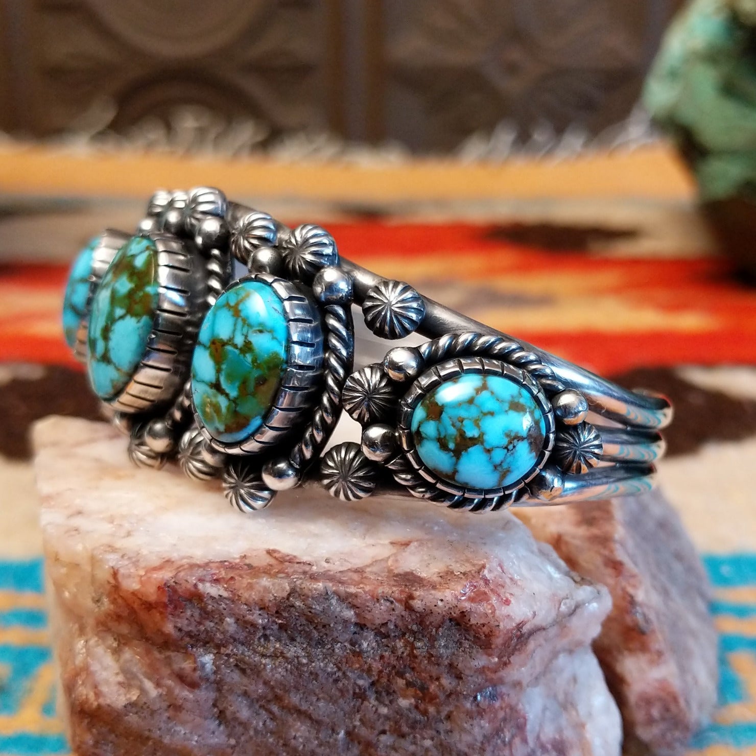 Sterling silver pentad cuff with Kingman turquoise set in round bezels, framed by twisted rope, star, and dotted accents.