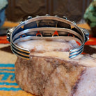 Sterling silver pentad cuff with Kingman turquoise set in round bezels, framed by twisted rope, star, and dotted accents.