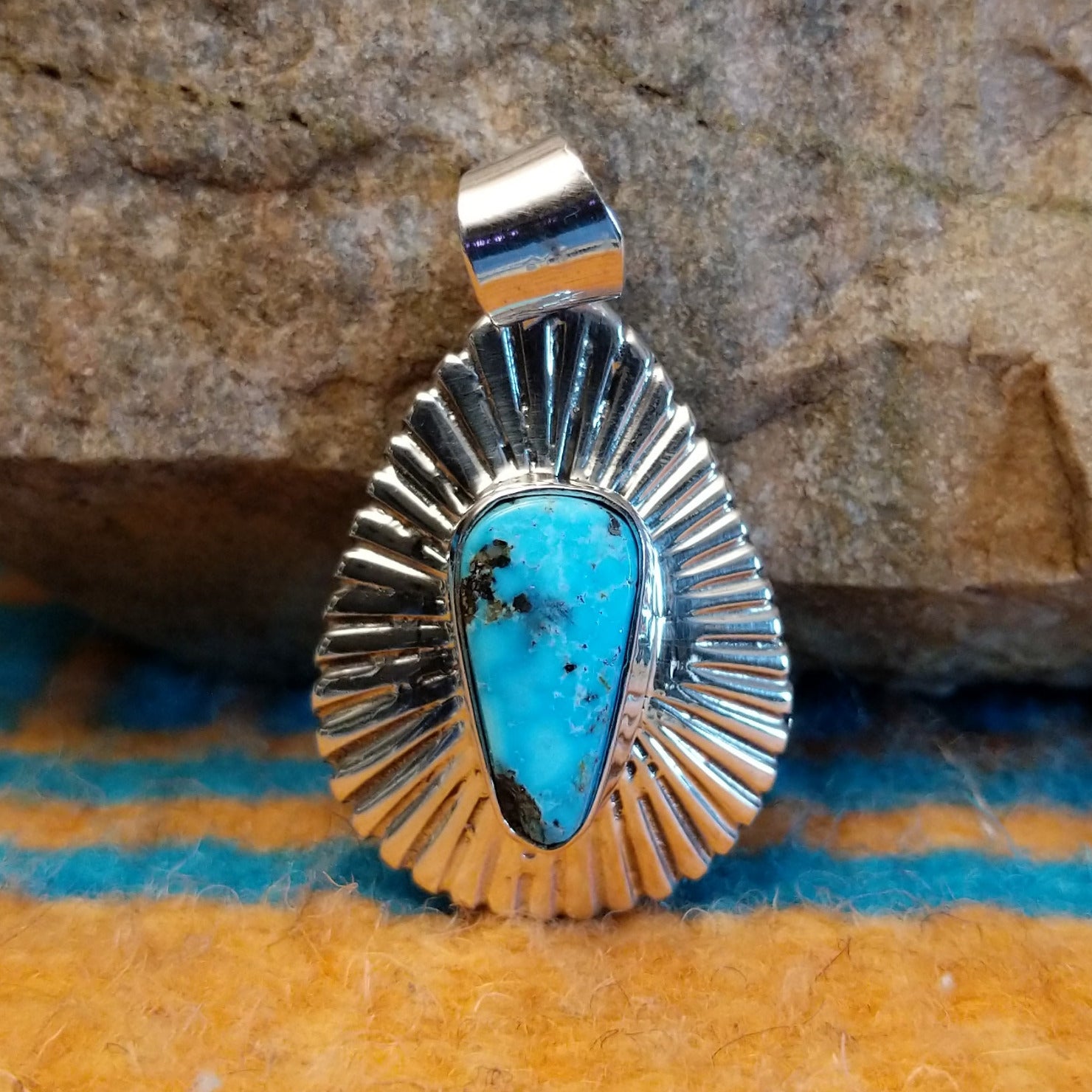 Sterling silver pendant with Kingman turquoise set in the triangular bezel, framed by the ray setting.