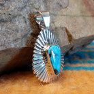 Sterling silver pendant with Kingman turquoise set in the triangular bezel, framed by the ray setting.