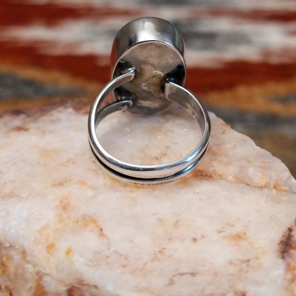 Brushed sterling silver band of the ring.