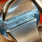 Close-up of the artisan's stamped signature.