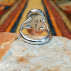 Kingman Turquoise Shadowbox Ring featuring a large oval blue turquoise stone with natural matrix, set in sterling silver with an oxidized shadowbox setting, notched border, and split-shank band; underside view.