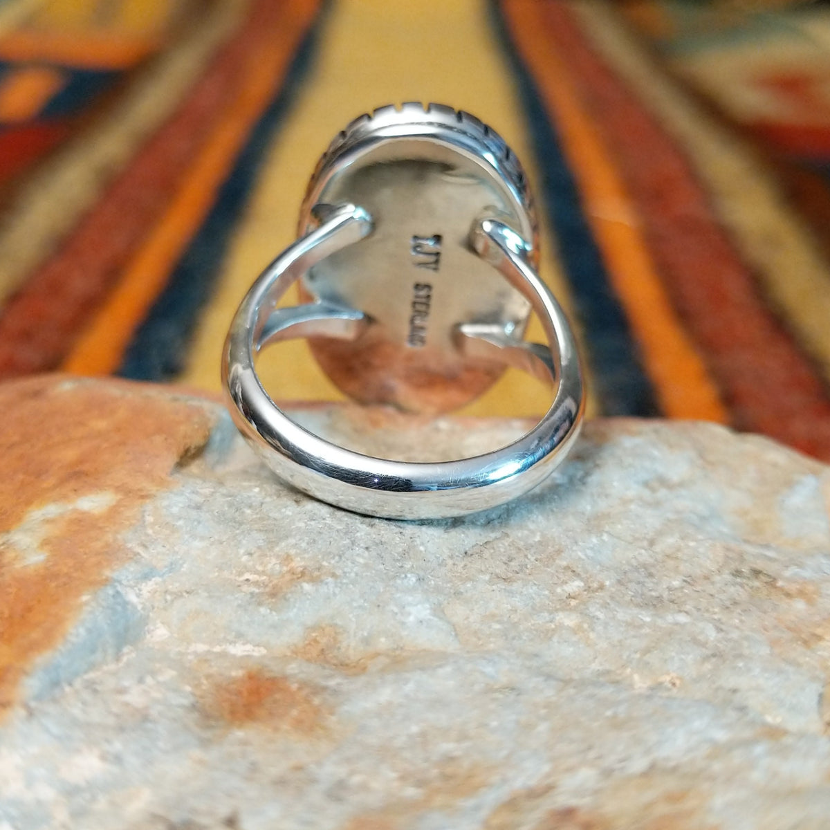 Kingman Turquoise Shadowbox Ring featuring a large oval blue turquoise stone with natural matrix, set in sterling silver with an oxidized shadowbox setting, notched border, and split-shank band; underside view.
