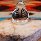 Sterling silver ring with Kingman turquoise set in round-triangle bezel, framed by twisted rope accents.