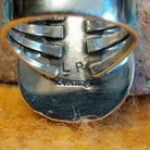 Close-up of the artisan's stamped signature.