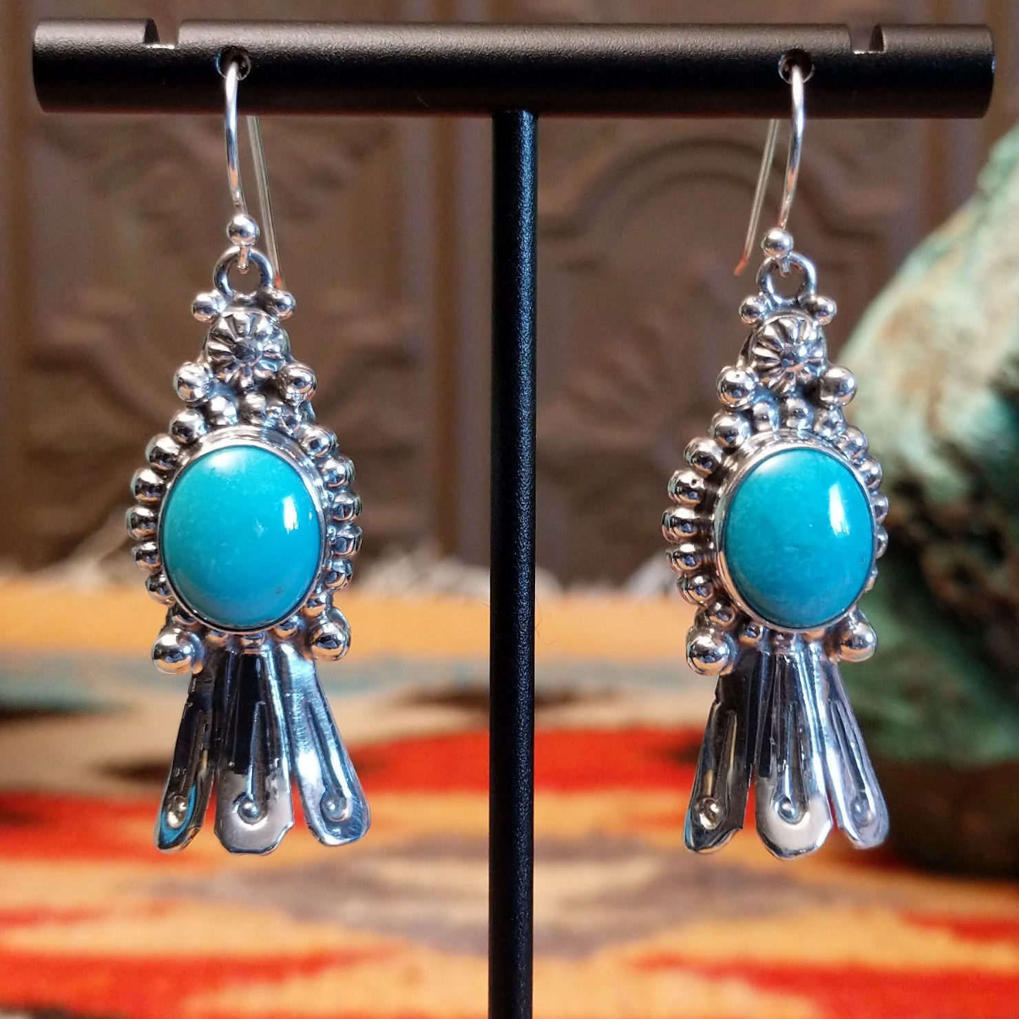 Sterling silver squash blossom earrings with Kingman turquoise set in the round bezels.