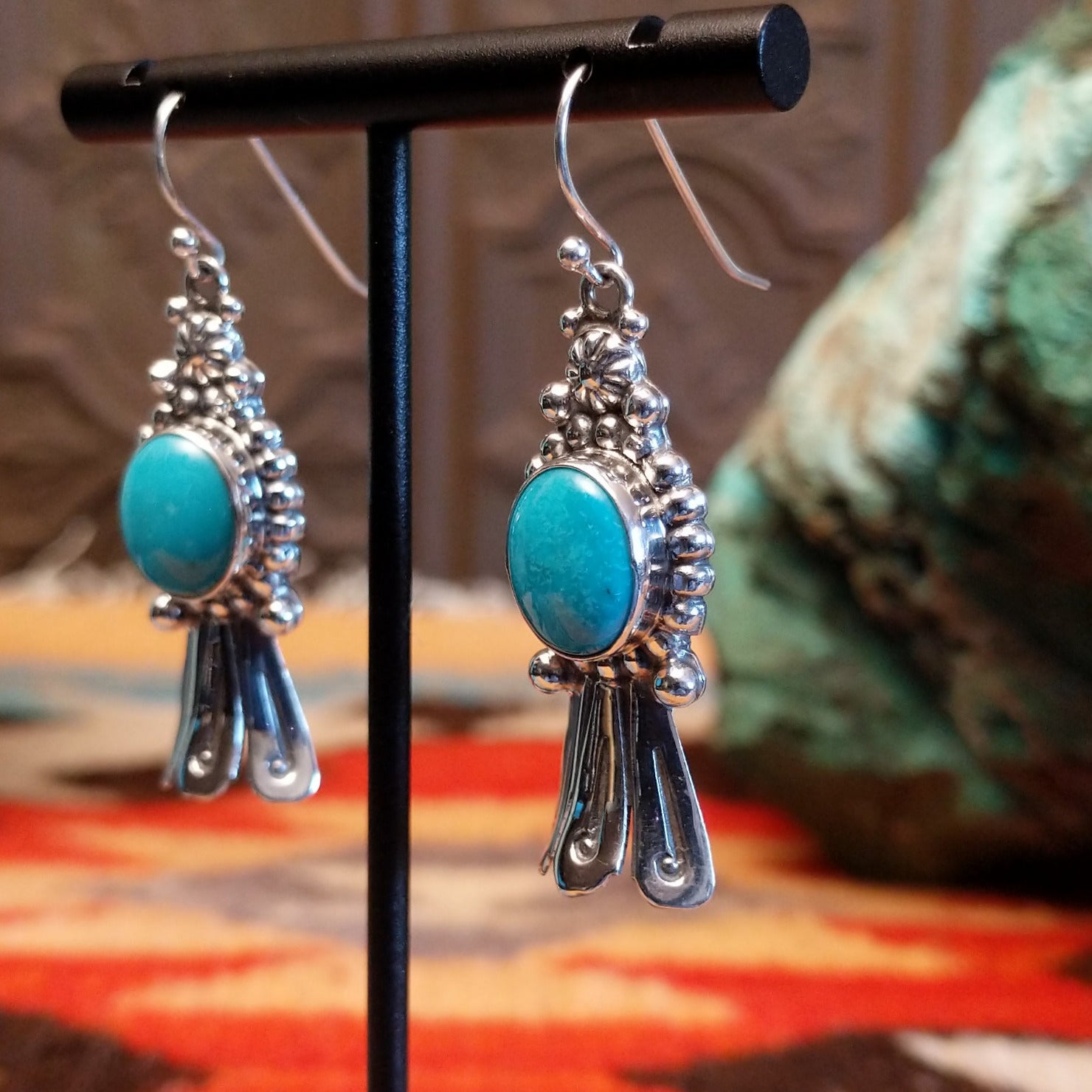 Sterling silver squash blossom earrings with Kingman turquoise set in the round bezels.