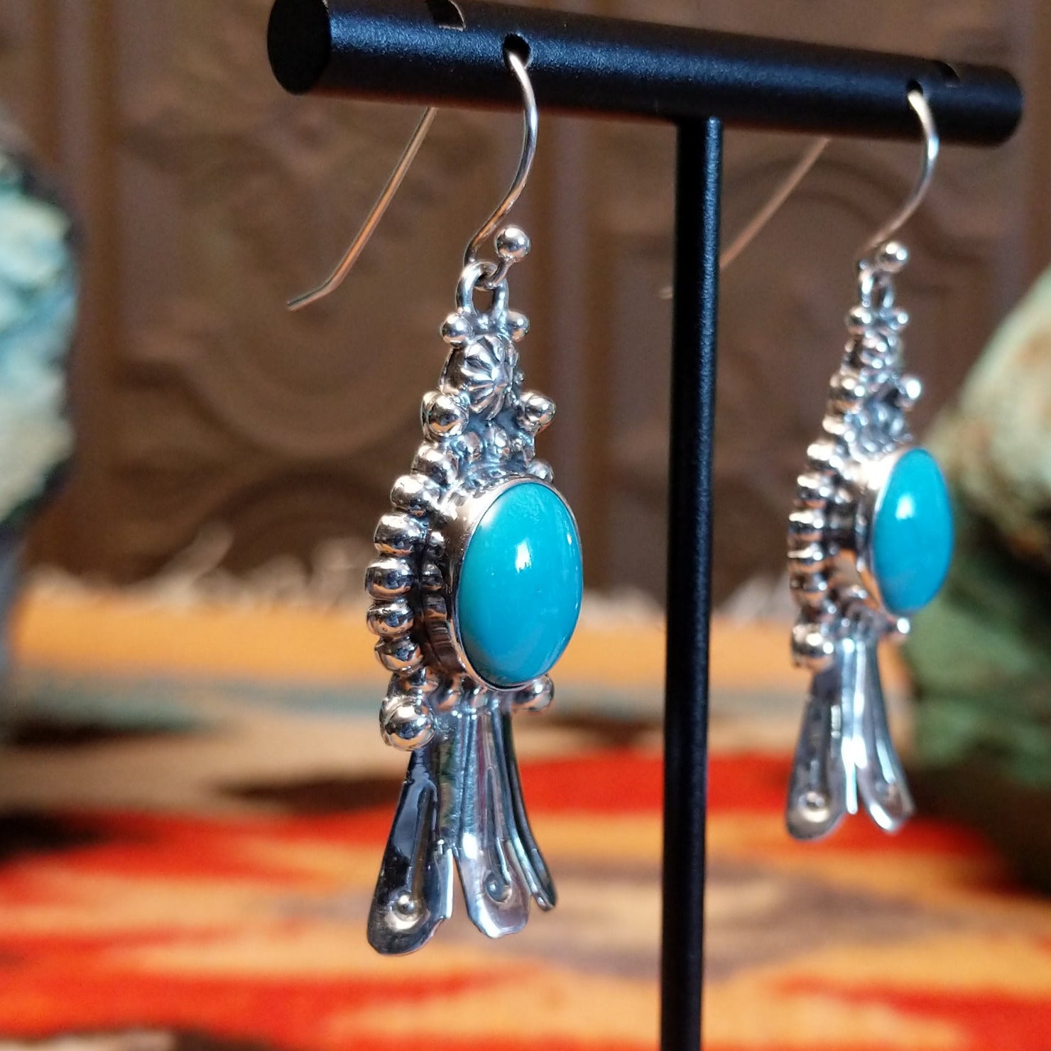 Sterling silver squash blossom earrings with Kingman turquoise set in the round bezels.