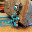 Sterling silver pendant with Kingman turquoise set in oval bezels that create a starburst design.