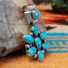 Sterling silver pendant with Kingman turquoise set in oval bezels that create a starburst design.