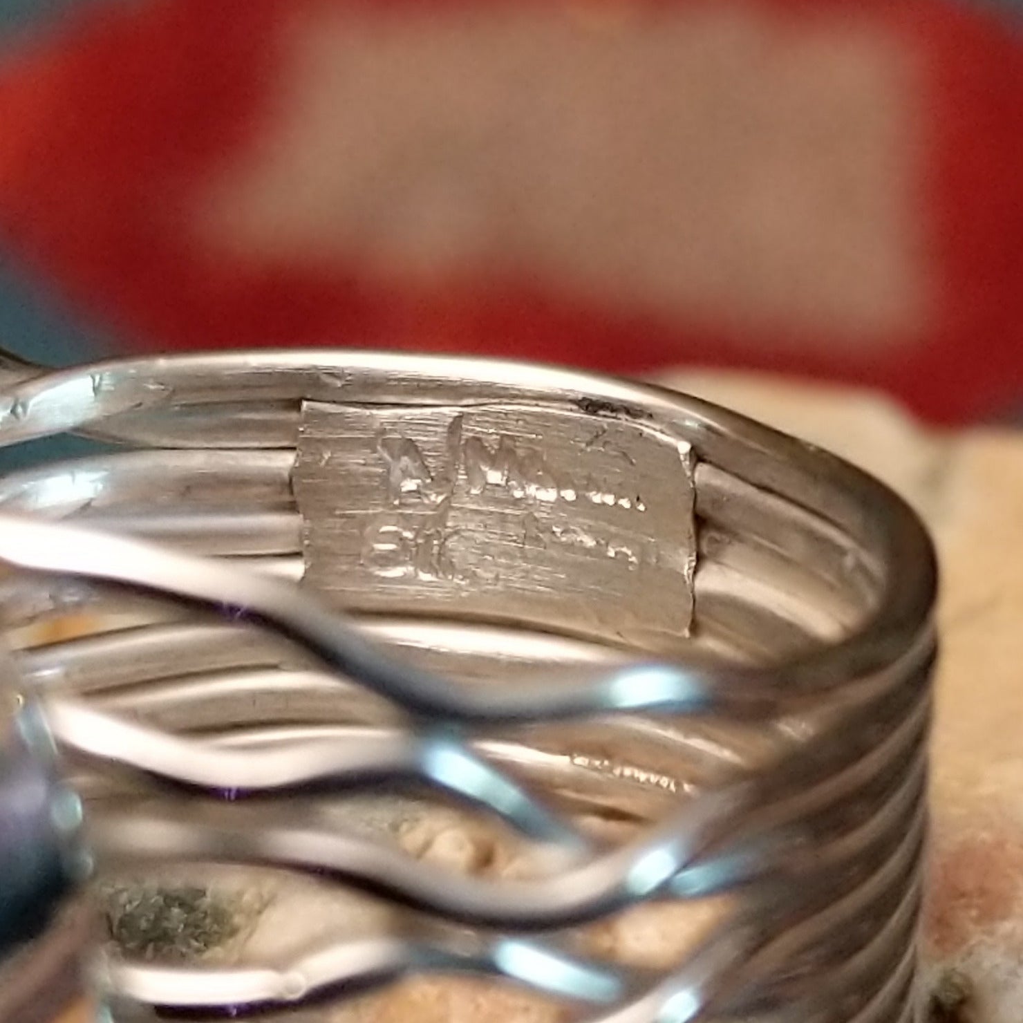 Close-up of the artisan's stamped signature.