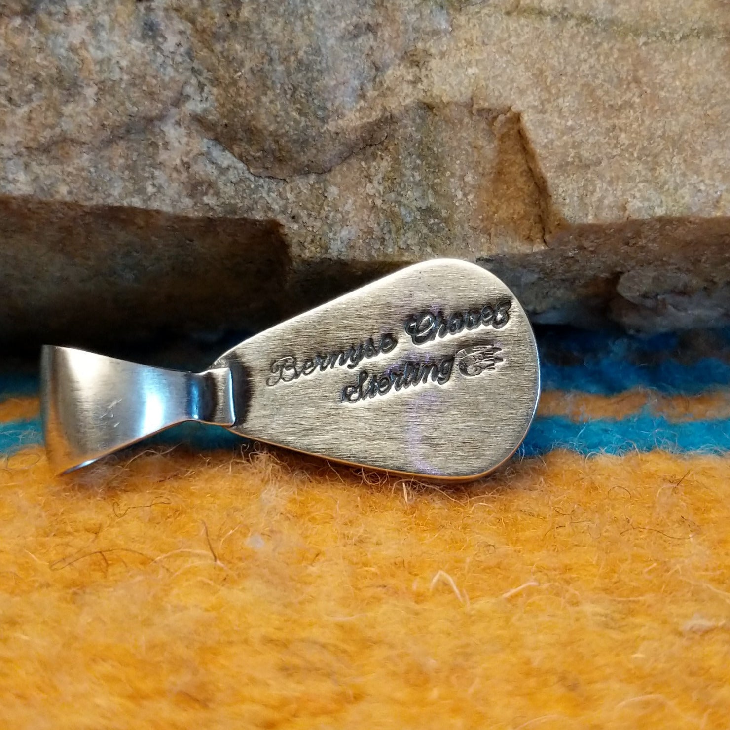 Close-up of the artisan's stamped signature.