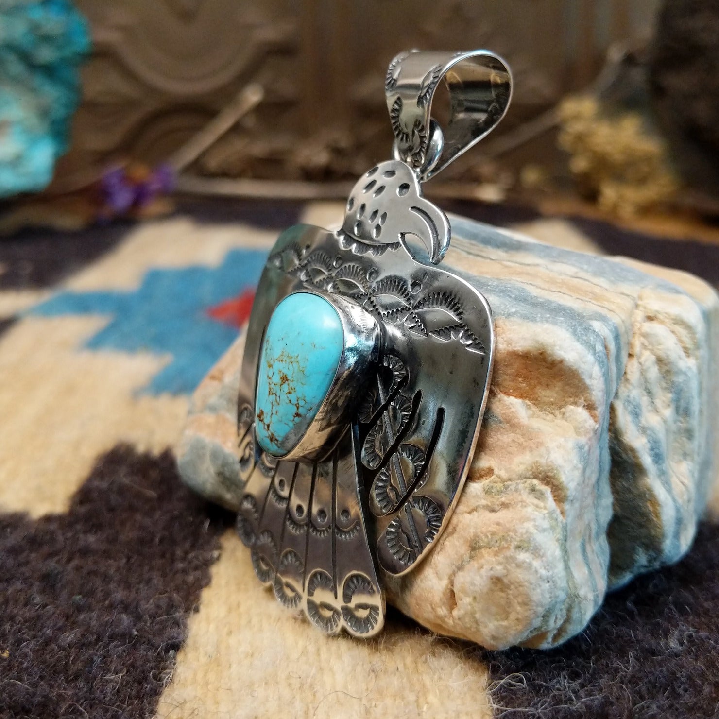 Sterling silver thunderbird pendant with Kingman turquoise set in a bezel.
