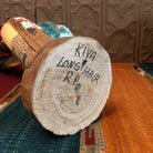 The artisan's signature is found on the base.