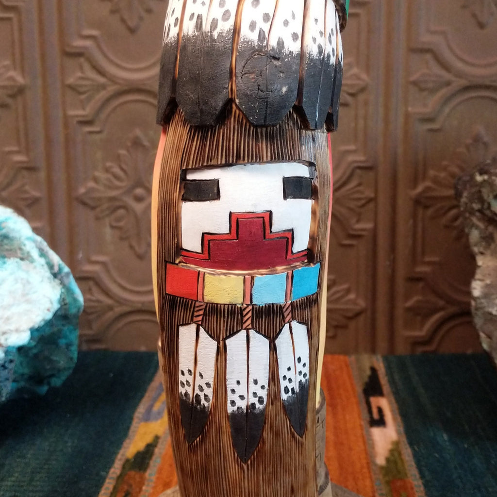 A close-up of the secondary face and painted feathers.