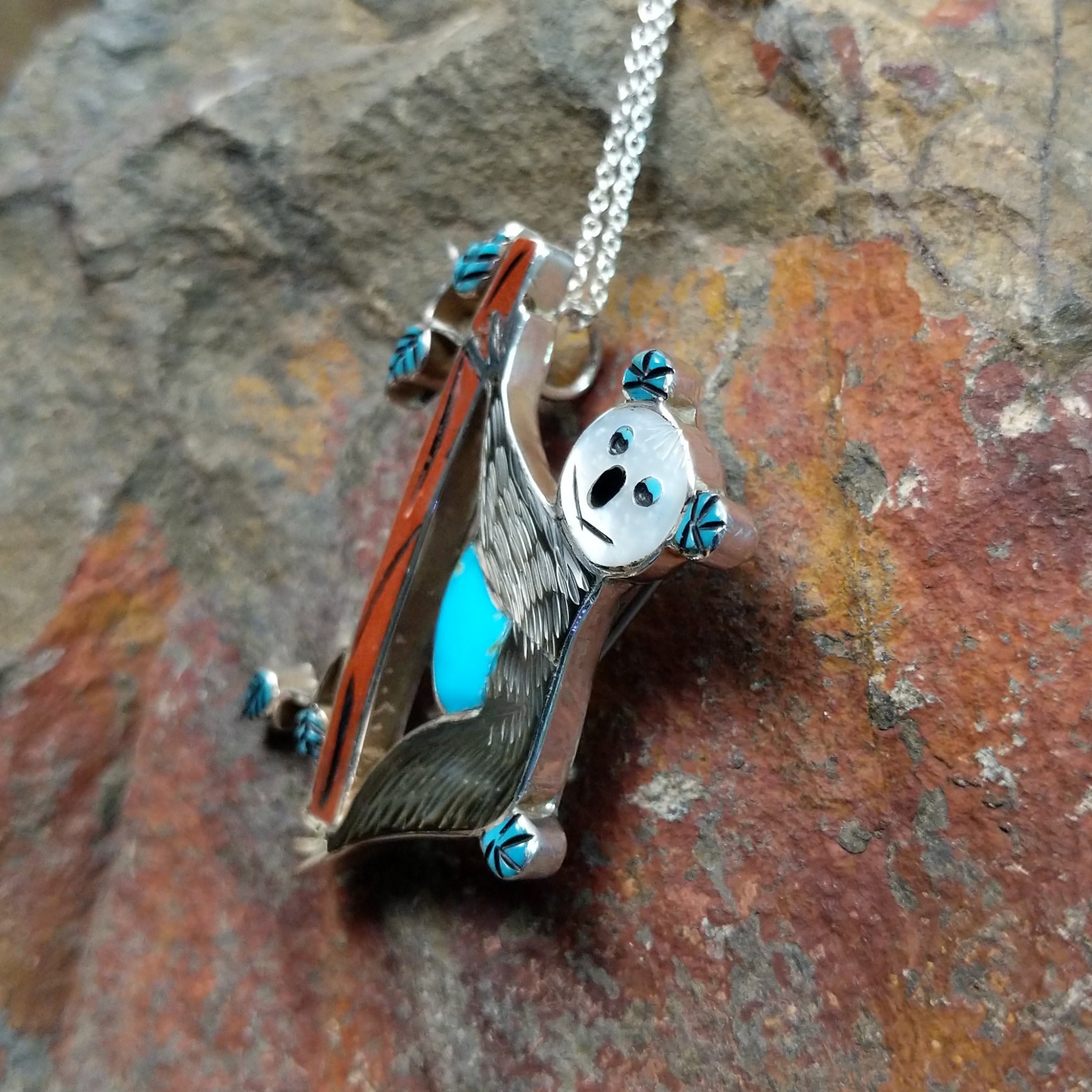 Handcrafted sterling silver koala pin and pendant by Valerie Comozona, featuring detailed inlay and a convertible pin-to-pendant design; side view.