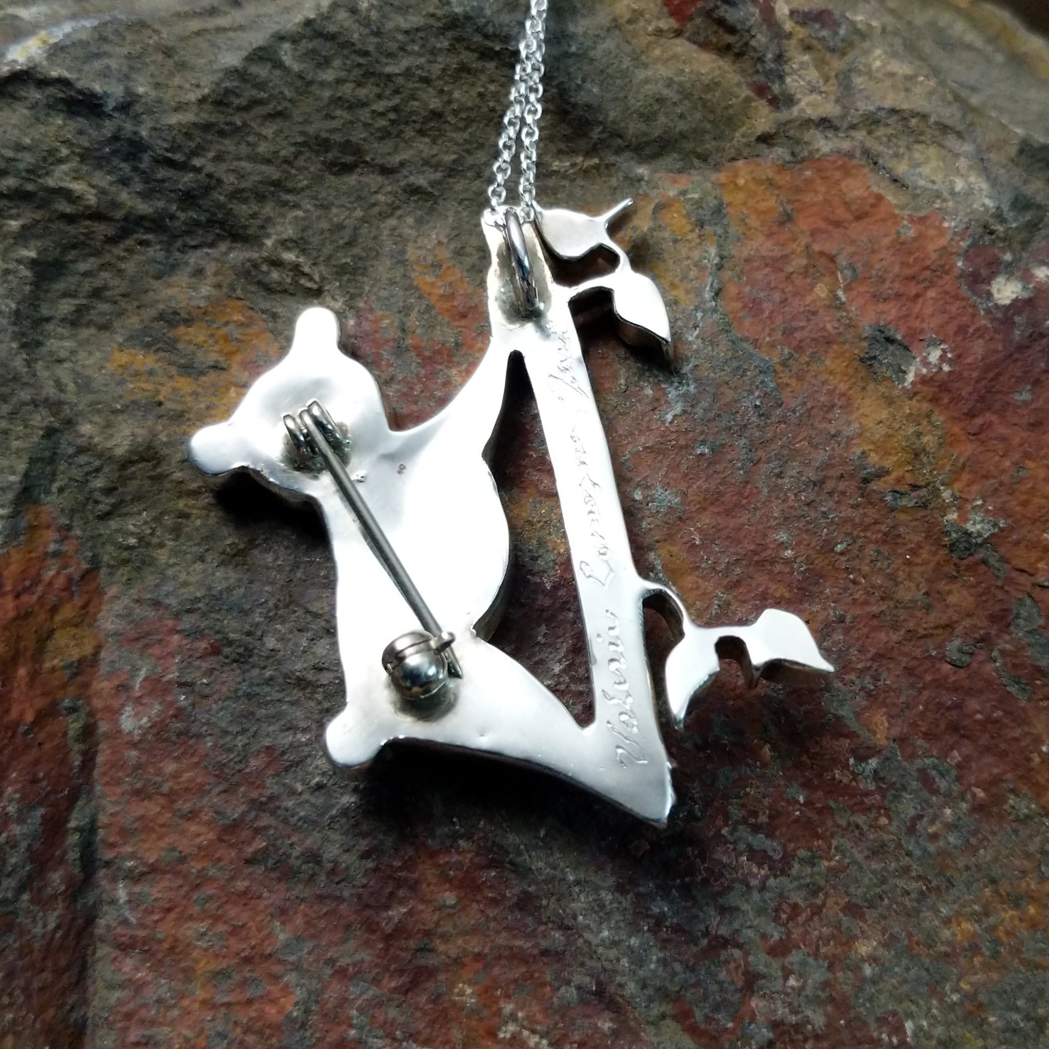 Handcrafted sterling silver koala pin and pendant by Valerie Comozona, featuring detailed inlay and a convertible pin-to-pendant design; artisan signature.