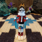 Mini Kokopelli kachina by Rosalind Grey with black-and-white face, white fur collar, feathered crest, and red body.