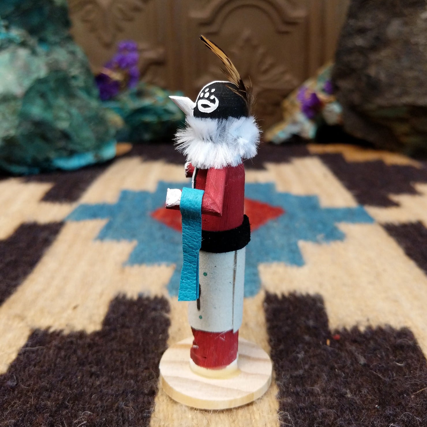 Mini Kokopelli kachina by Rosalind Grey with black-and-white face, white fur collar, feathered crest, and red body.