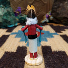 Mini Kokopelli kachina by Rosalind Grey with black-and-white face, white fur collar, feathered crest, and red body.
