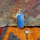 Sterling silver pendant with lapis set in the bezel, framed by twisted rope accents.