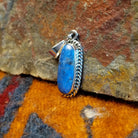 Sterling silver pendant with lapis set in the bezel, framed by twisted rope accents.