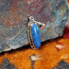 Sterling silver pendant with lapis set in the bezel, framed by twisted rope accents.