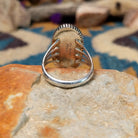 Sterling silver Lapis Lazuli ring by Tim Bedah featuring a capsule-shaped deep blue stone with natural pyrite inclusions; underside view.