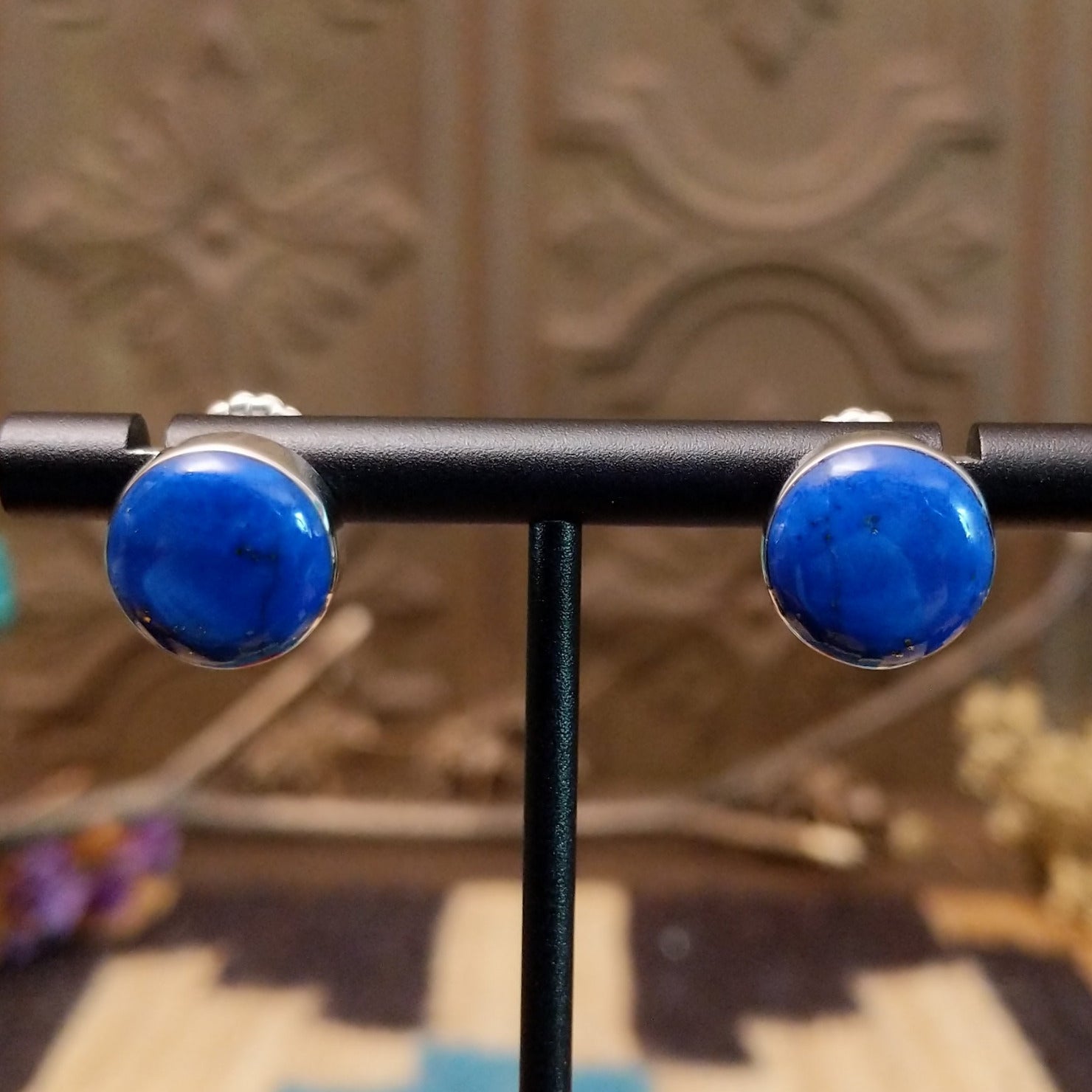 Sterling silver earrings with lapis set in round bezels.