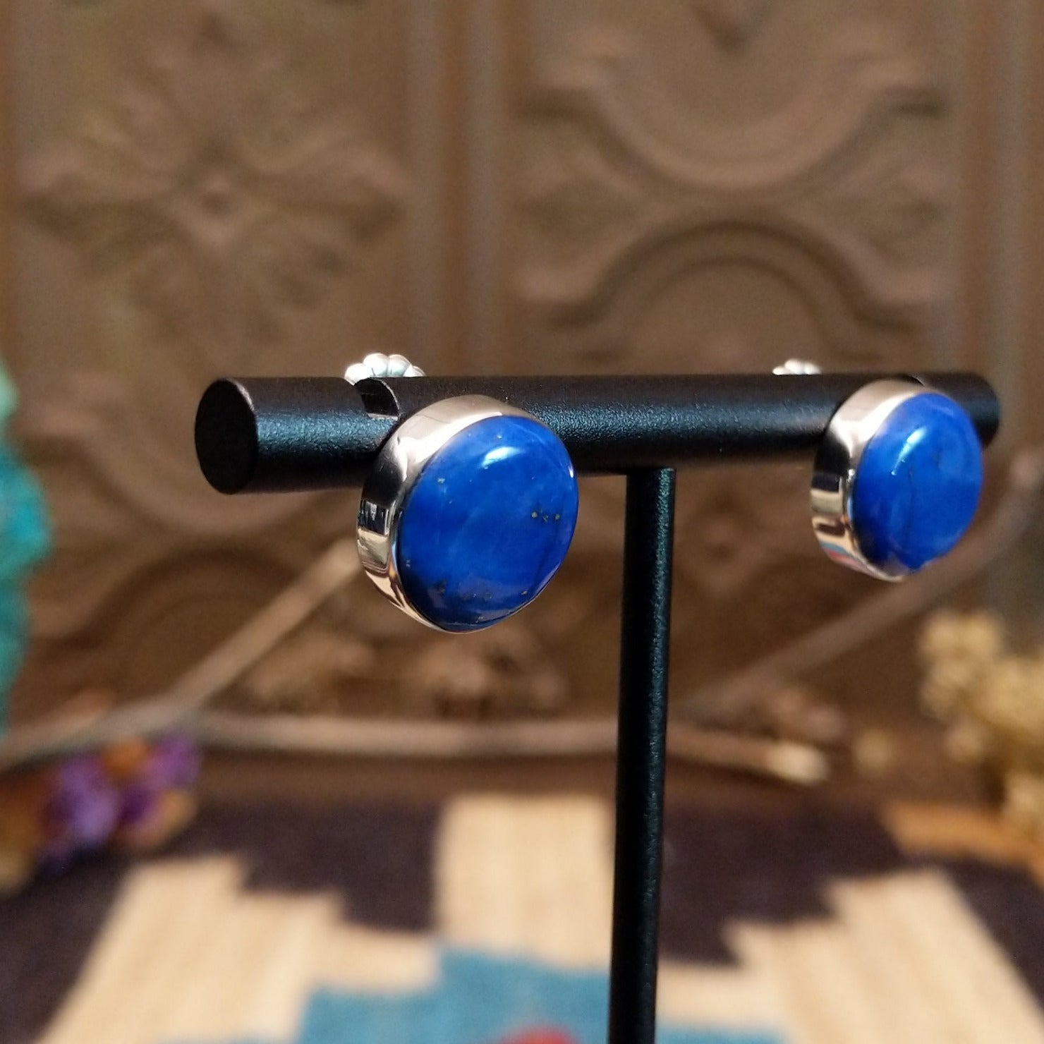 Sterling silver earrings with lapis set in round bezels.