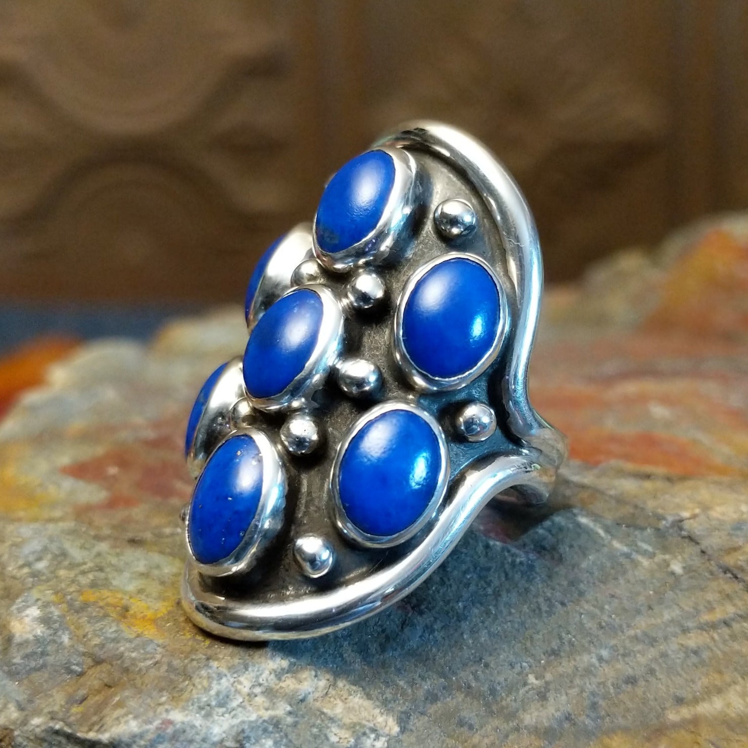 Sterling silver ring with lapis set in clustered bezels.
