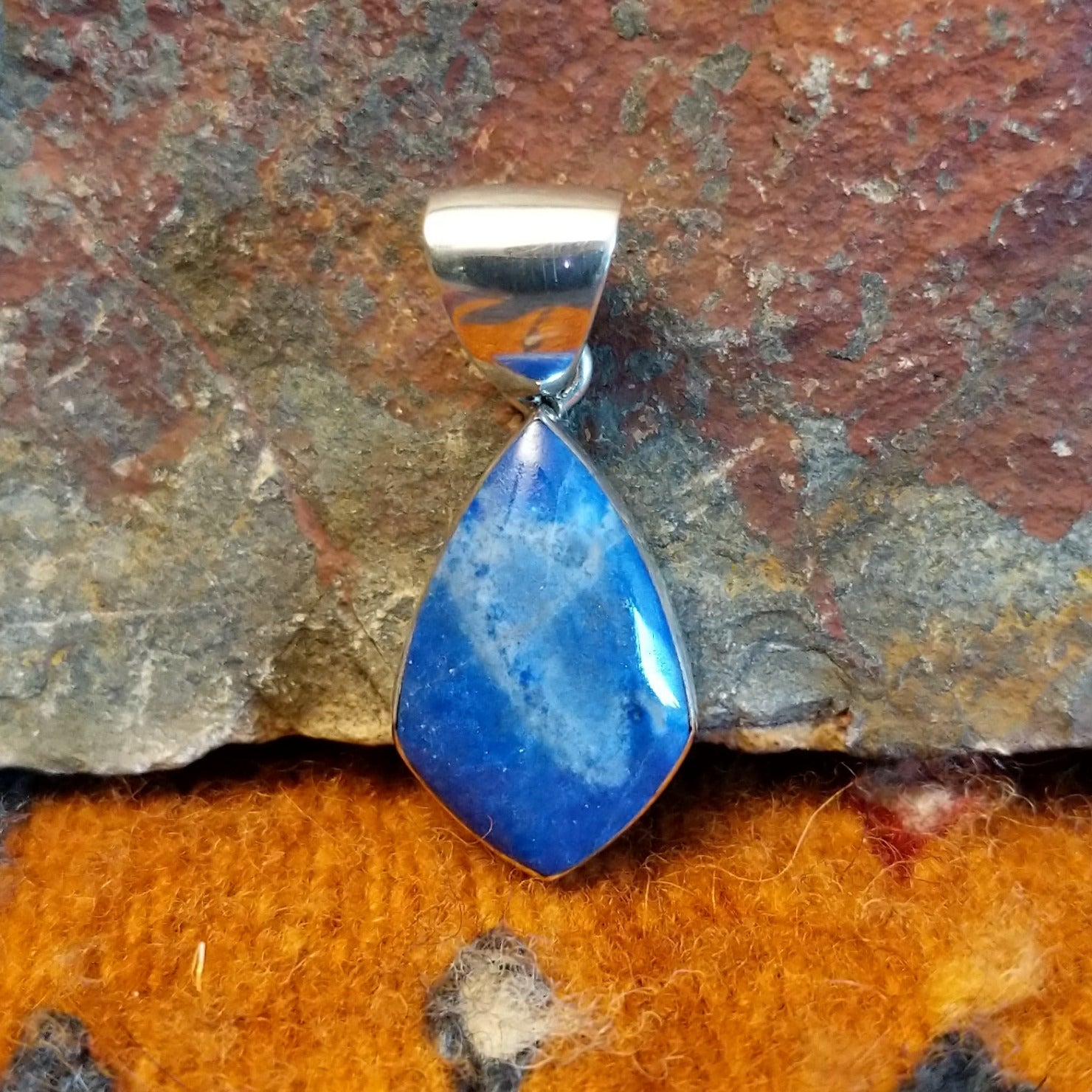 Sterling silver deltoid pendant with turquoise set in the bezel.
