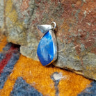 Sterling silver deltoid pendant with turquoise set in the bezel.
