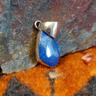 Sterling silver deltoid pendant with turquoise set in the bezel.