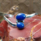 Sterling silver cuff bracelet with lapis set in a duo bezel, framed by dotted accents.