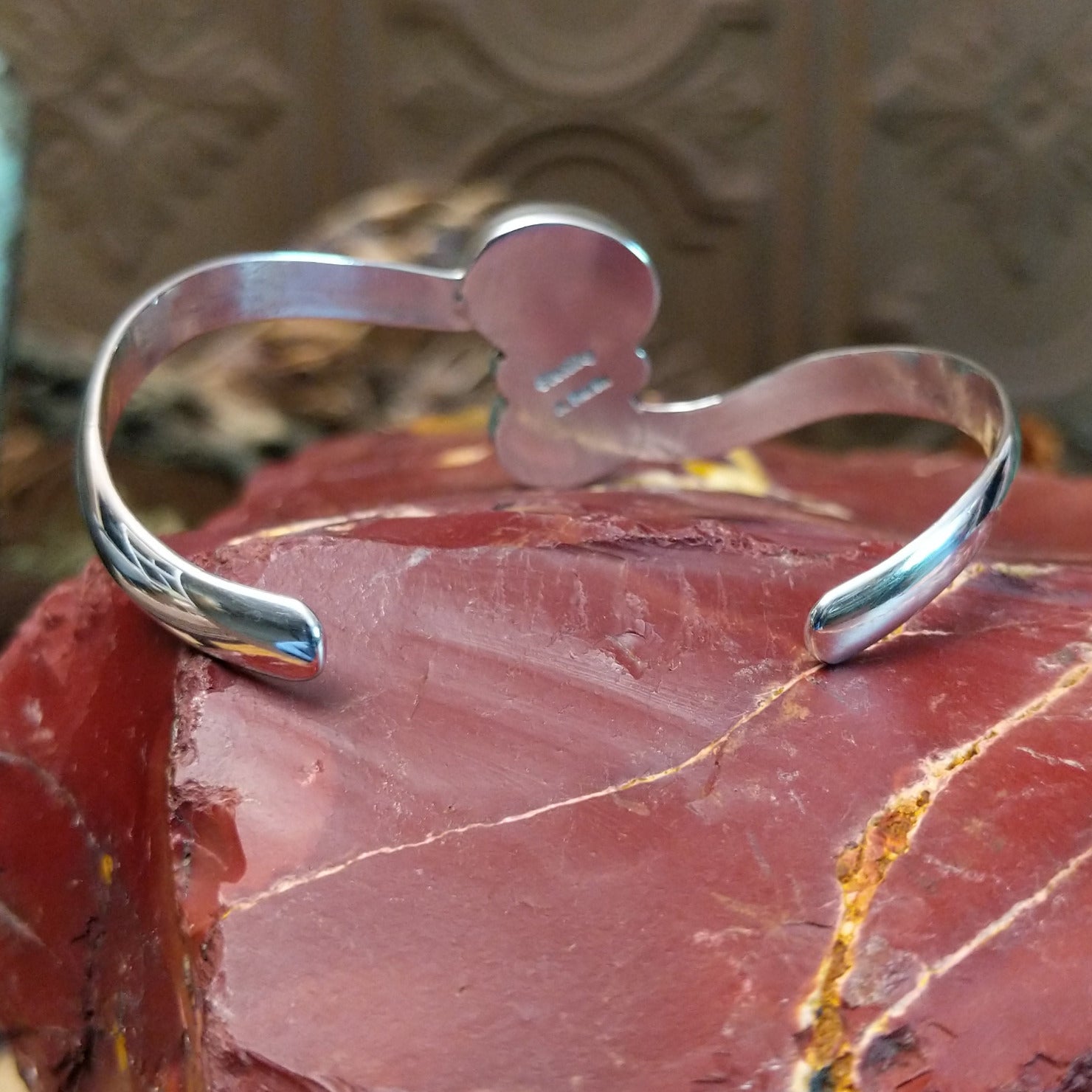 Sterling silver cuff bracelet with lapis set in a duo bezel, framed by dotted accents.