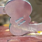 Close-up of the artisan's stamped signature.