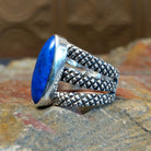Sterling silver ring with lapis set in the bezel and tri-layered knurled band.