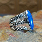 Sterling silver ring with lapis set in the bezel and tri-layered knurled band.