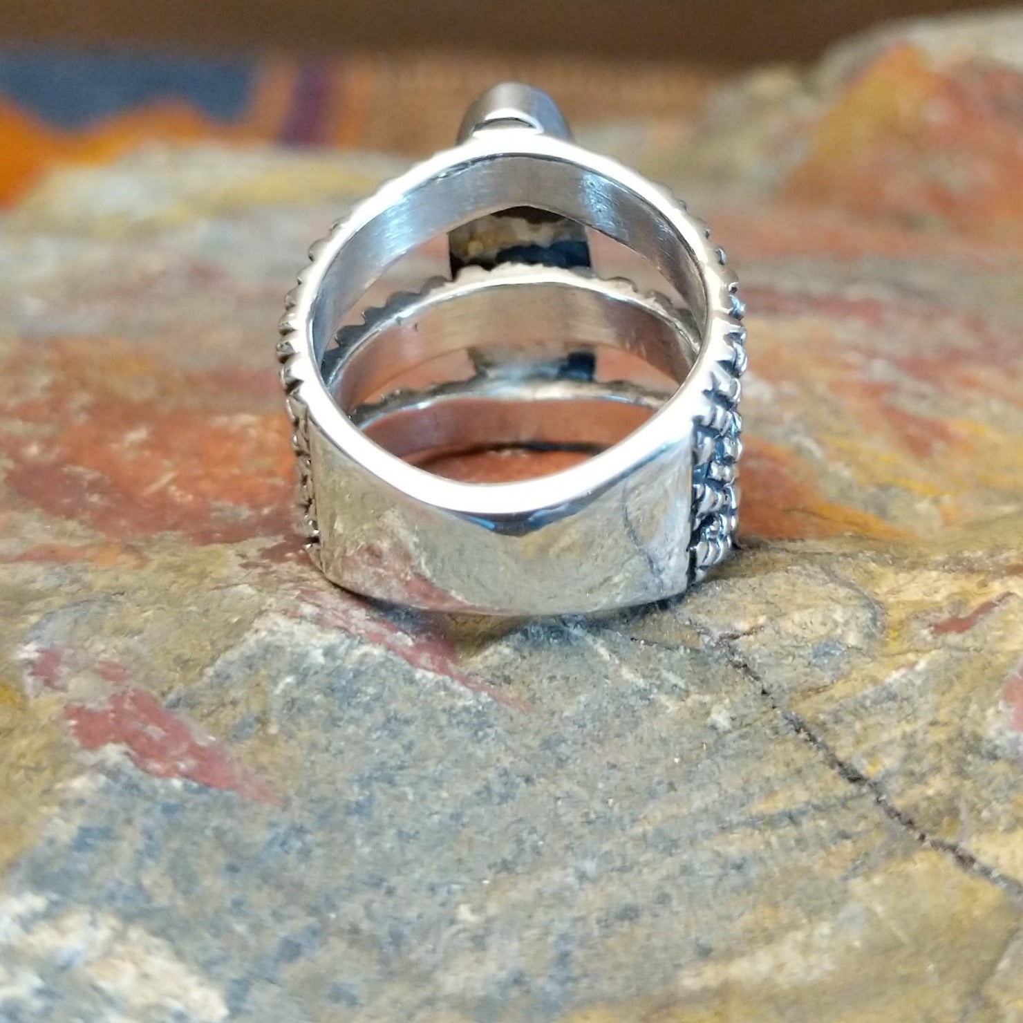 Sterling silver ring with lapis set in the bezel and tri-layered knurled band.