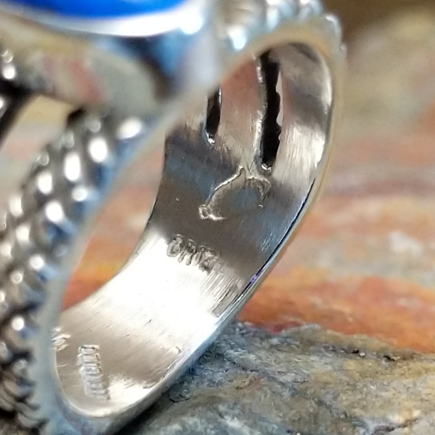 Close-up of the artisan's stamped signature.