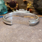 Sterling silver cuff featuring a navette-shaped lapis stone with silver beadwork and twisted rope detailing.