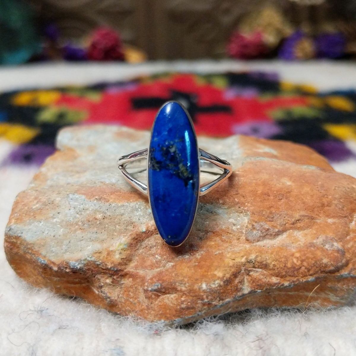 Vibrant Lapis Ring by Cathy Webster featuring an elongated royal-blue lapis stone with natural matrix set vertically in sterling silver with an open split-shank band.