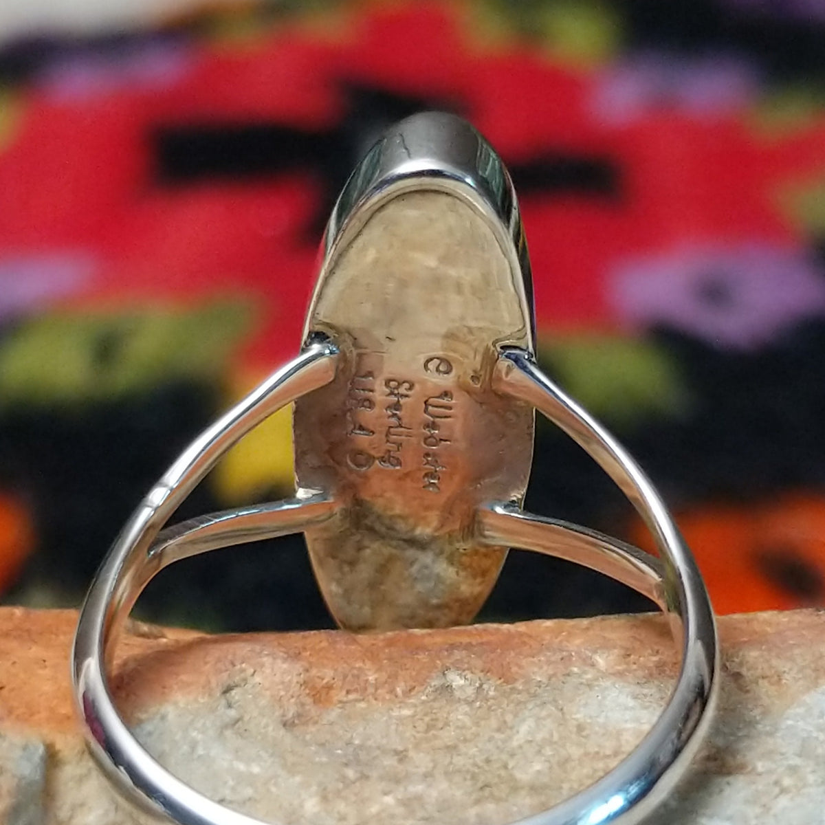Vibrant Lapis Ring by Cathy Webster featuring an elongated royal-blue lapis stone with natural matrix set vertically in sterling silver with an open split-shank band; artisan and Sterling Silver stamp.