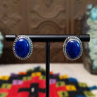 Lapis Oval Earrings by Priscilla Smith featuring deep blue oval lapis cabochons set in polished silver with twisted rope-style borders.