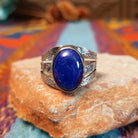 Lapis Oval Ring by Raymond Coriz featuring a large oval blue lapis stone set in Sterling Silver with a split band and intricate stamped detailing.
